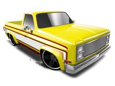 a yellow pickup truck parked on top of a white floor