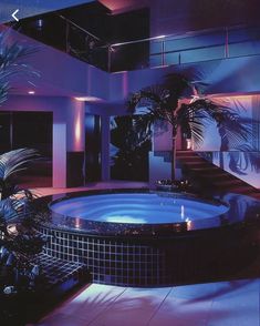 an indoor jacuzzi tub surrounded by palm trees