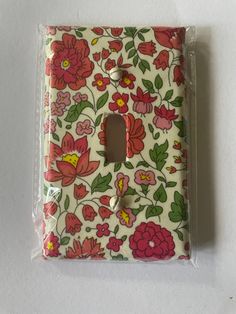 a flowered light switch plate cover with a floral pattern on it's side