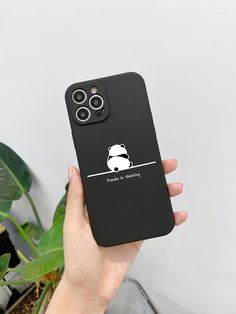 a person holding an iphone case with a panda on it