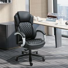 an office chair sitting in front of a desk with a view of the city outside