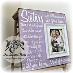 a wooden frame with an image of two women and the words sisters are written on it