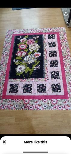 a quilted table runner with flowers on it and the words, more like this