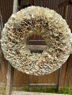 a wreath hanging from a wooden ladder