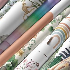 many different colored rolls of wrapping paper on top of each other in various patterns and colors