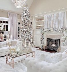 a living room decorated for christmas with white furniture