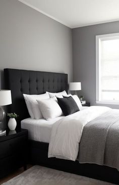 a bedroom with gray walls and white bedding