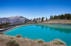 a blue lake surrounded by mountains and trees