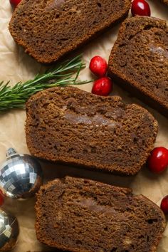 slices of chocolate christmas bread with cranberries and evergreen sprigs