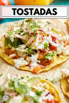 two tortillas topped with shredded cheese, lettuce and tomatoes