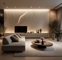 a living room with a couch, coffee table and large screen tv on the wall