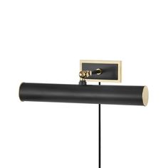 a black and gold wall mounted light on a white background with a metal pole in the foreground