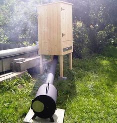 a large black object sitting on top of a wooden box in the middle of a field