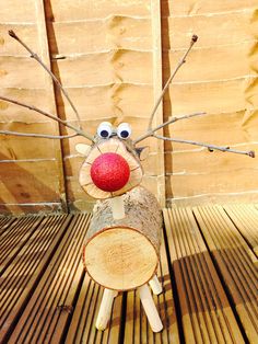 a wooden log with a red nose and big eyes