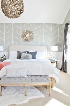 a white bed sitting in a bedroom next to a window