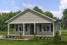 a small gray house sitting on top of a lush green field