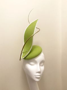 Handmade and hand stitched rounded base headpiece, in light fresh green wool felt, stiffened to give clean structure. Bonded with white grosgrain wired edging, screwed in with metal gold sprayed screws and gold sprayed ostrich feather quills once heated and hand curled. A unique creation made with Modern Fitted Hats For Spring, Fitted Felt Cloche Hat, Fitted Cloche Felt Hat For Spring, Spring Fitted Cloche Felt Hat, Fitted Felt Party Hats, Elegant Fitted Felt Mini Hats, Green Short Brim Felt Hat For Kentucky Derby, Adjustable Green Brimmed Fascinator, Green Adjustable Brimmed Fascinator