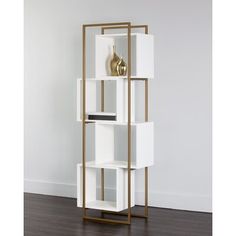 a white and gold bookcase with three shelves on each side, against a wall