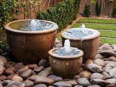 two water fountains sitting on top of rocks