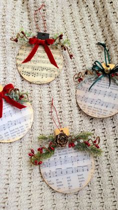 three christmas ornaments with sheet music on them