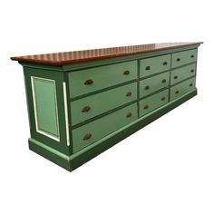 a green dresser with wooden top and drawers