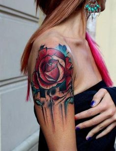 a woman's arm with a rose tattoo on it