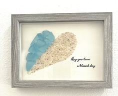 a shadow frame with a blue and white heart in it that says, may you have a shared day