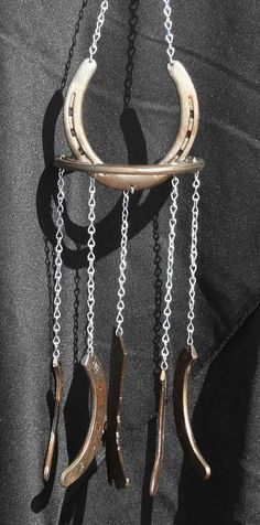 an image of a horse shoe hanging from chains