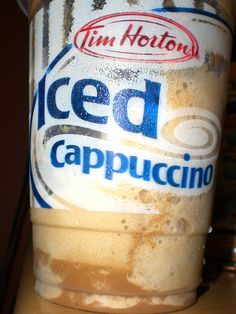 a jar of iced cappuccino sitting on top of a table