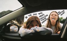 two women in the back seat of a car, one with her mouth open and another with her hand on her head