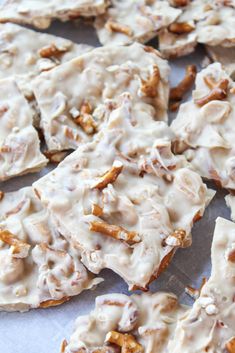 there are many pieces of food that is on the table together, including crackers and nuts