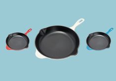 three frying pans on a blue background with one empty and the other not