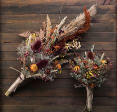 two bouquets of dried flowers on a wooden surface