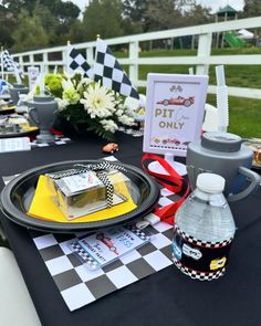 a black table topped with plates and cups