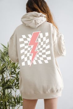 Get Obsessed with the Checkered Aesthetic with this cute Lightning Bolt Hoodie! This Preppy Hoodie is super comfy! Size up for a Trendy Oversized Look! ♥ Hello and Welcome to Meaningful Tees Shop! ♥ Printed on the most popular Unisex Hoodie, the Gildan 18500 is 50% Cotton / 50% Poly. The soft fleece lining makes it super Comfy and is sure to become your new favorite! ♥ All of our items are made to order with care for each customer : ) ♥ Please allow 3-7 BUSINESS days (usually 3-5) for your item to be created PLUS shipping time via USPS ♥ This Unisex Hoodie fits like a Men's on Women, but is not overly large. ♥ For a RELAXED FIT, your usual size will typically work, but please consult the Size Chart in the Listing Photos ♥ For an OVERSIZED FIT, size up 1, 2, or 3 Sizes! (2 sizes up is the m Trendy Cotton Top With Kangaroo Pocket, Trendy Hoodie With Kangaroo Pocket And Crew Neck, Trendy Crew Neck Hoodie With Kangaroo Pocket, Trendy Crew Neck Sweatshirt With Drawstring Hood, Trendy Hooded Hoodie With Graphic Print, Trendy Graphic Print Hooded Hoodie, Trendy Graphic Print Hoodie Sweatshirt, Cute Lightning Bolt, Checkered Aesthetic