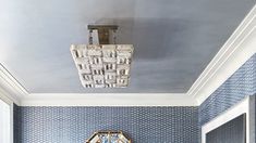 a bathroom with blue walls and white trim