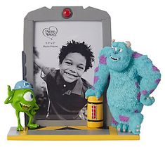 the monsters are posed in front of an old photo frame with a pencil and toothbrush