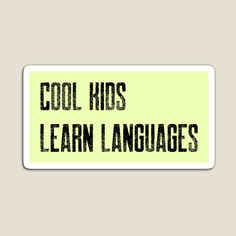 the words cool kids learn languages are written in black ink on a yellow sticker