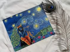 an artistic painting with a peacock feather laying on it's side next to a piece of art