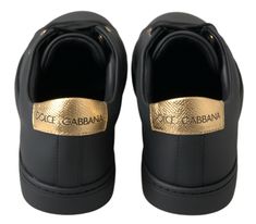 Step into luxury with these stunning, brand new classic sneakers from the iconic fashion house Dolce & Gabbana. Crafted from premium 100% leather in a sleek black with gold accents, these shoes are not just a statement of style, but a testament to Italian craftsmanship. The durable rubber sole ensures comfort and longevity, while the distinctive logo detail adds an exclusive touch to your every step. Elegance meets street style with these luxurious sneakers, made in Italy. Material: 100% Leather Luxury Black Sneakers With Leather Sole, Dolce And Gabbana Shoes Sneakers, Dolce And Gabbana Men Shoes, Luxury Black Belt Buckle With Gold-tone Logo Plaque, Dolce And Gabbana Gold Heels, Haute Couture Brands, High Heel Stiefel, Dolce Gabbana Shoes, Classic Sneakers