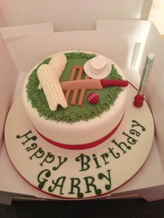 a birthday cake in the shape of a cricket ball and bat