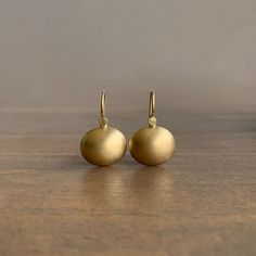 Opulent ovular matte gold drops for a classic everyday pair. 18k yellow gold Cushions are 14mm x 12mm (9/16" x 1/2") Earrings hang 7/8" from the ear Yellow Gold Oval Earrings With French Hook, Elegant Rounded Everyday Earrings, Yellow Gold Oval Jewelry With French Hook, Classic Matte Finish Jewelry Gift, Yellow Gold Rounded Earrings For Gift, Yellow Gold Earrings Gift, Modern Gold Jewelry With Matte Finish, Minimalist Gold Jewelry With Matte Finish, Gold Matte Finish Jewelry Gift