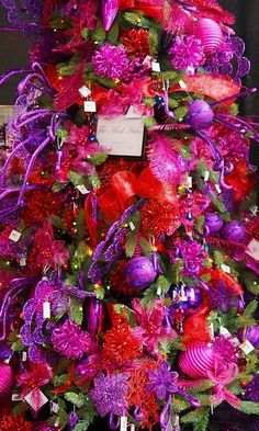 a christmas tree decorated with purple and red ornaments