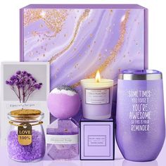 a purple gift set with candles, soap and other items