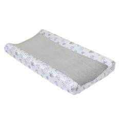 a white and gray baby crib mattress with elephants on the side, in front of a