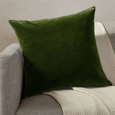 a green pillow sitting on top of a couch