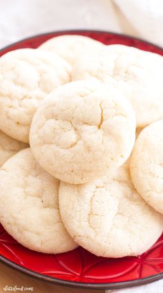 a red plate filled with white cookies on top of a table