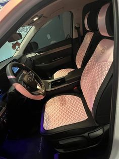 the interior of a car with pink and black seats