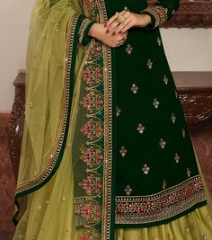 COLOR : Dark Green & Olive Green FABRIC : Top - Georgette, Bottom - Net Lehenga & Santoon Pants, Dupatta - Net WORK : Resham & Zari Embroidery, Hand Work, Stones, Sequins, Motifs, Lace Border OCCASION : Wedding, Reception, Party Wear, Festival ADDITIONAL INFO : The outfit comes with complimentary santoon pants besides the lehenga. READY-TO-WEAR : No STITCHING : Available as semi-stitched fabric, can be stitched using standard size option (+$30). Note: There might be a slight color variation due Dark Green Mehndi Outfit, Dark Green Combination Outfit, Green Clothes Combination, Phulkari Punjabi Suits, Dark Green Lehenga, Suit Designs Indian Style, Green Contrast Color, Plain Kurti, Kurti Styles