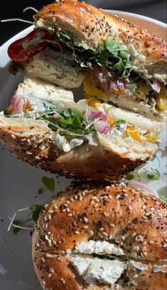 the sandwich is cut in half and ready to be eaten on the plate for consumption